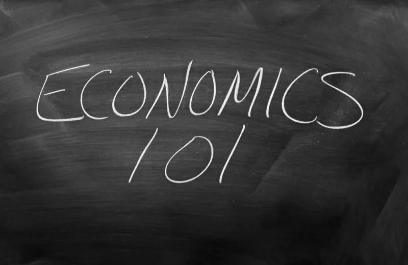 The words "Economics 101" written on a chalkboard.