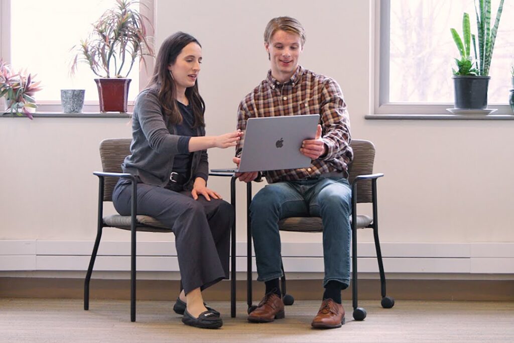 MSAE student Gina Occhipinti and MSAA student Trevor Petrin collaborate at a laptop computer.